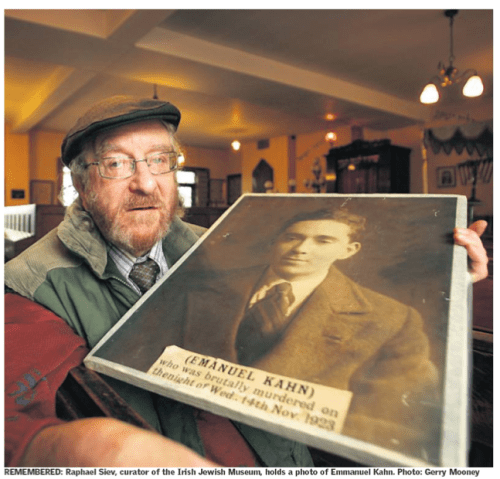 Raphael Siev (RIP), former curator of the Jewish Museum, with a picture of Ernest Kahn. Credit - The Sunday Independent (24 June 2007)