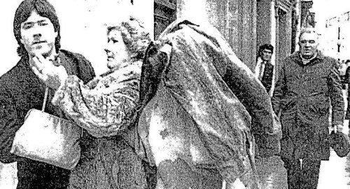 One of the three men covers his face leaving the courts (Irish Press).